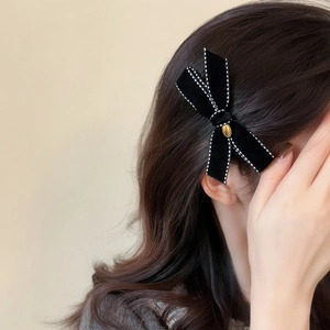Elegant black velvet bow hair clip with white stitching and gold oval metal detail