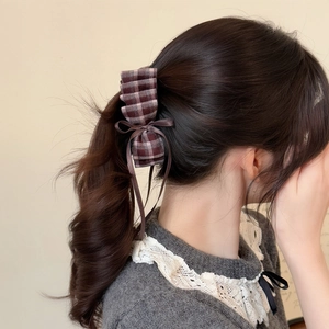 Brown plaid bow hair clip with ribbons on wavy high ponytail hair for women