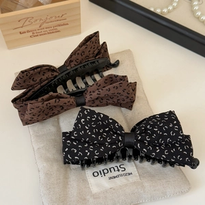 Vintage leopard and polka dot bow banana clips set on a rustic linen background