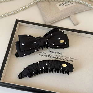 French style hair clip set with black polka dot bow and banana clip on a tray