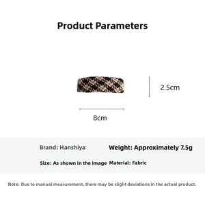 Detail showing an 8cm brown houndstooth fabric hair clip with exact size measurements