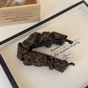 Brown leopard print scrunchie banana clip for women featuring pleated fabric hair accessory