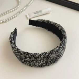 Detail of tweed headband with classic black and white weave and silver glitter silk