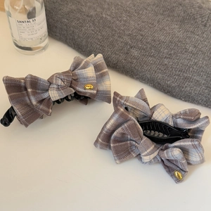 Elegant grey plaid fabric bow hair clip with vintage golden plate on white background