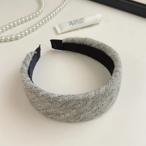 Detailed macro view of tweed hairband with gold silk thread and black anti-slip lining