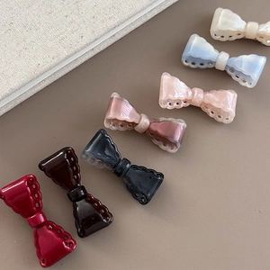 Set of seven vintage hollow bow hair clips in marble texture acetate and diverse colors