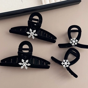 Elegant set of black velvet hair claws featuring sparkling rhinestone snowflake charms