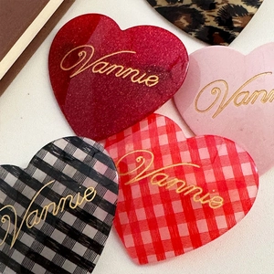 Set of four acetic heart hair clips in burgundy, pink, and checkered patterns