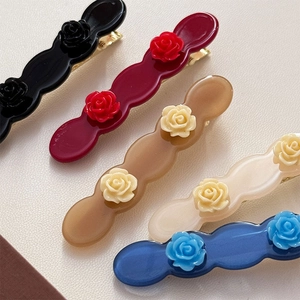 Elegant wavy acetate rose flower hair clips in black, wine red, brown, and cream white