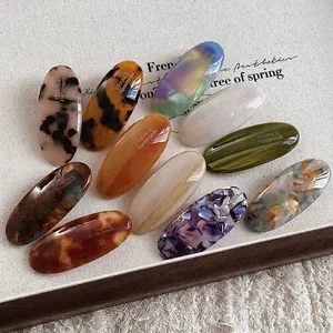Set of 11 vintage oval acetate hair clips with diverse tortoiseshell and marble patterns