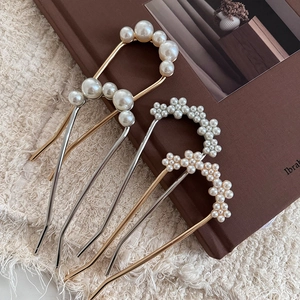 Elegant French U-shaped pearl hair pins with rhinestones on vintage book setting