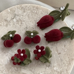Vintage flocking hair clips with red cherries and green tulips on marble tray