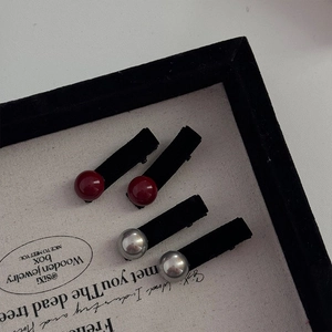 Elegant velvet hair clips with red and silver pearl beads in a display tray for women