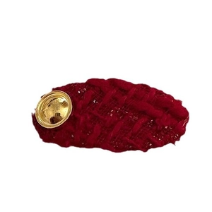 New Year Red Woolen Heart Hair Clip featuring a gold logo and knitted winter texture