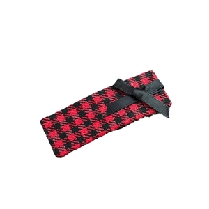 Vintage red houndstooth hair clip with black satin bow in preppy academy style