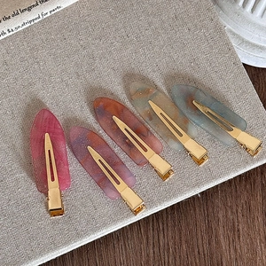 Five-piece set of acetate duckbill hair clips with marble texture on vintage background