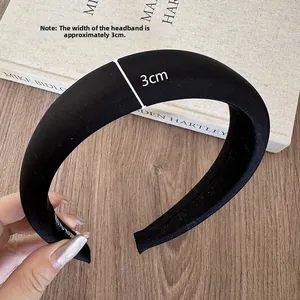 Close-up of a premium black padded headband with a 3cm width and smooth satin finish
