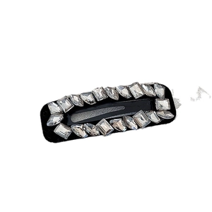 Vintage rhinestone hair clip with sparkling crystals on a black rectangle base