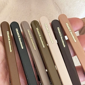Set of seven vintage matte hair clips in earthy tones with gold handmade lettering