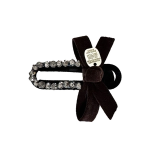Elegant black velvet bow hair clip with sparkling rhinestones and silver metal tag