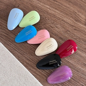 Waterdrop acetate hair clips in eight assorted colors with golden handmade logo stamp