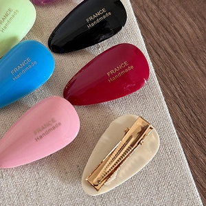 Waterdrop acetate hair clips in multiple colors with golden handmade logo accents