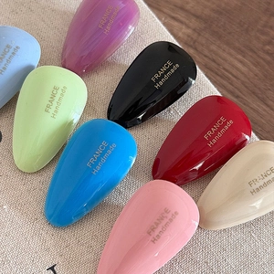 Set of colorful water-drop acetate hair clips with gold handmade lettering on fabric