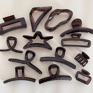Detailed set of 12 glossy amber hair claws in various geometric shapes for styling