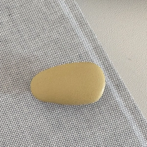 Detail view of mustard yellow teardrop hair clip with a subtle matte textured finish