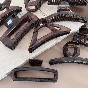 Set of amber brown geometric hair claws in glossy resin on light background
