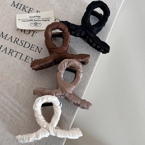 Detailed set of four fabric wrapped shark hair clips in black, brown, and cream colors