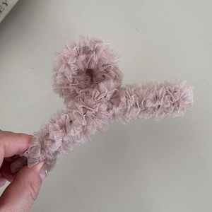 Macro detail of the pink lace mesh shark clip showing delicate fabric layers and texture