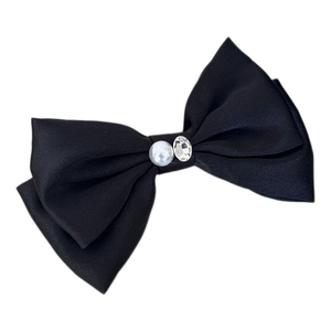 Elegant black satin bow hair clip featuring a white pearl and sparkling crystal center