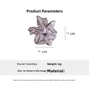 Detail showing a purple organza hair scrunchie with 18cm outer diameter and black edging