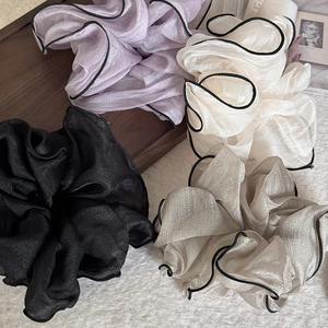 Detail of elegant organza hair scrunchies with black contrast edging in four colors