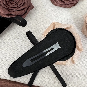 Detail view of black velvet back and durable metal snap clip on the hair flower clip