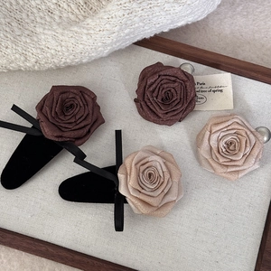 Elegant dried rose flower hair clip with vintage satin petals and black bow for women