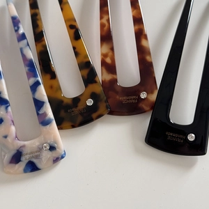 U-shaped acetate hair pins in leopard and tortoiseshell patterns with rhinestone accents