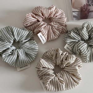 Set of four striped bubble cotton scrunchies with handmade tags in assorted colors