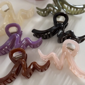 Set of six colorful large wavy hair claw clips in cream, green, and lilac for thick hair