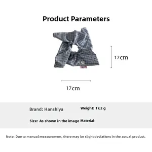 Blue and white checkered fabric scrunchie with floral detail measuring 17cm by 17cm