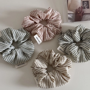 Set of 4 striped scrunchies with textured fabric in navy, red, brown, and black