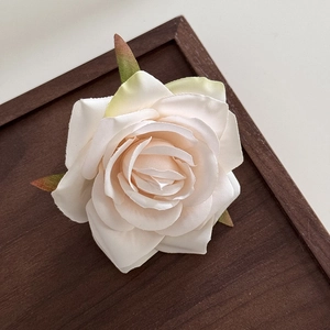 Detailed close-up of realistic cream rose flower clip with delicate silk fabric petals