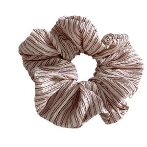 Striped seersucker scrunchie with red and cream fabric pleats for casual hairstyles