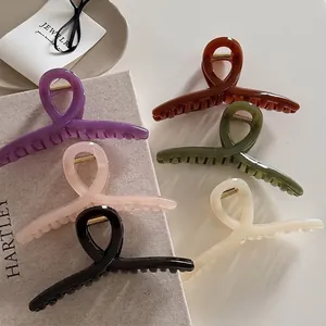 Minimalist glossy resin hair claws in six colors with strong gold metal springs