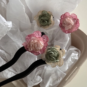 Elegant vintage camellia hair sticks with pink and green fabric flowers on wavy black base