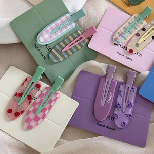 Glitter fruit hair clips with grape and cherry patterns on colorful display cards
