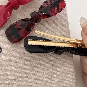 Acetate bow hair clips in red, plaid and black with gold duckbill clip backing