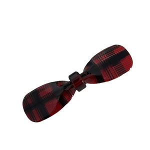 Acetate bow-shaped hair clip featuring a classic red and black plaid checkered pattern