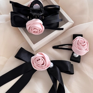 Elegant set with rose hair claw clips, satin bows, and pearls in a vintage style